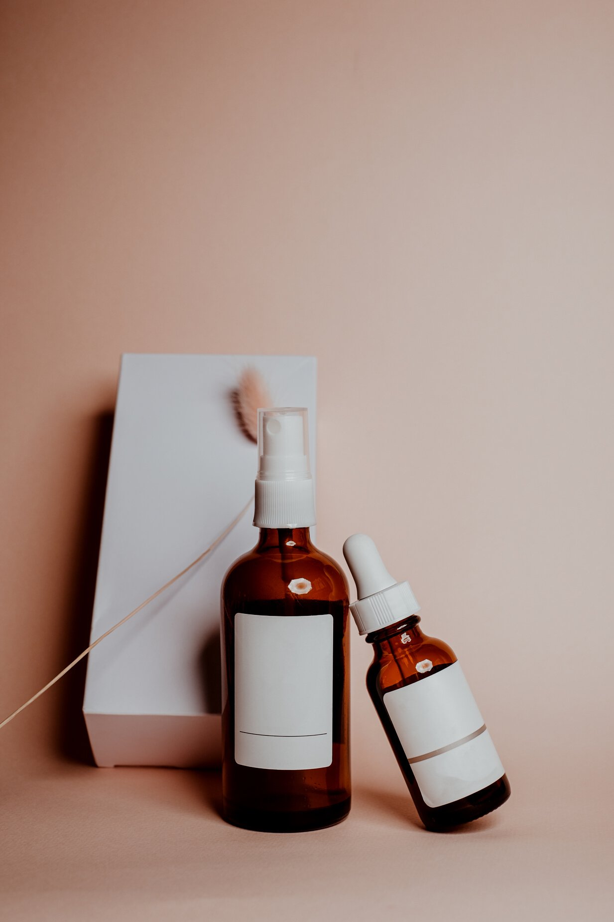 Bottles of Cosmetic Products with White Labels and Box